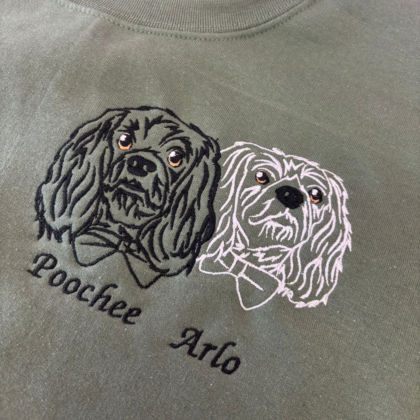Gray sweatshirt with embroidered dog designs and names 'Poochee' and 'Arlo'.